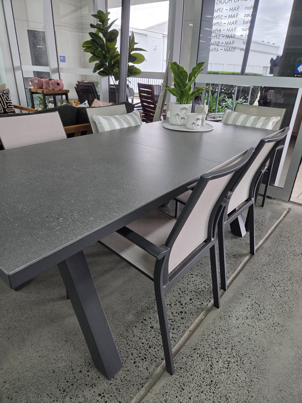 Atlanta extendable table with grey sintered stone table top, and Florida dining chairs with a beige sling