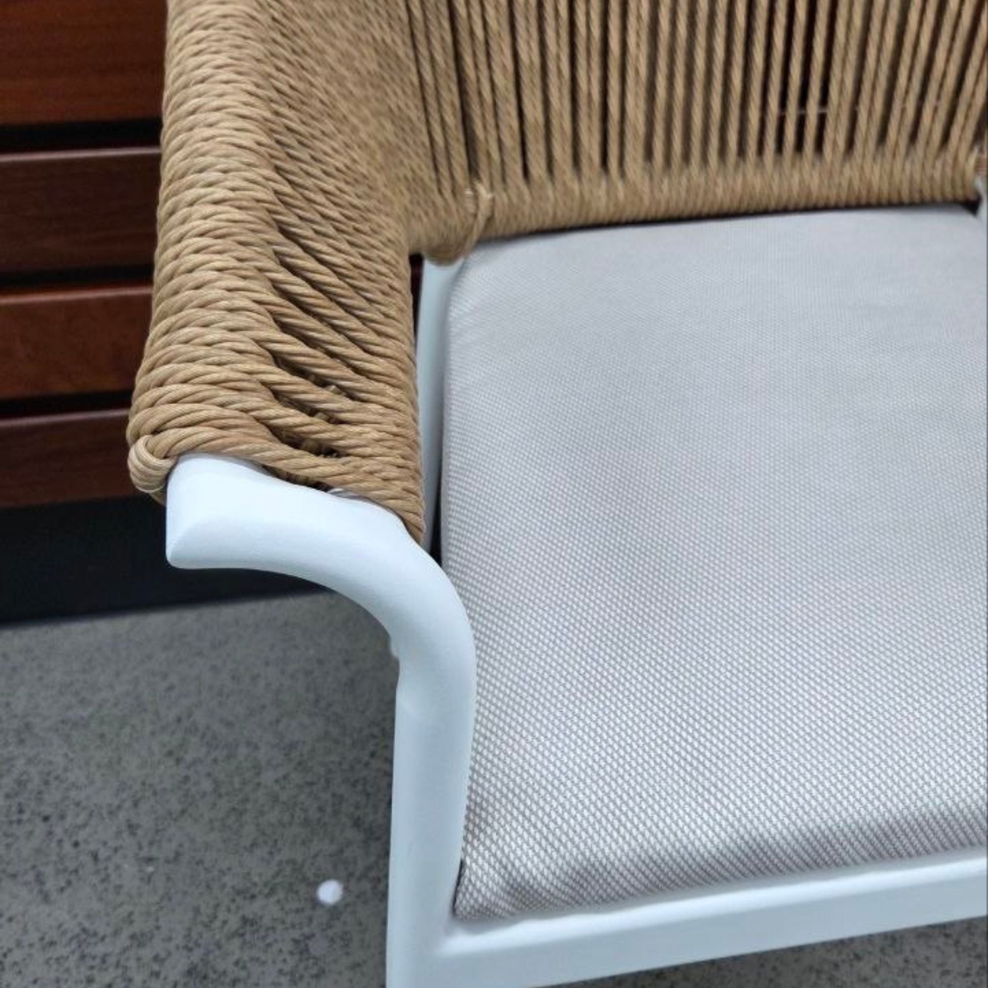 Close up of the armrest and cushions of the Celia Dining Chair - White frame and Natural rope 