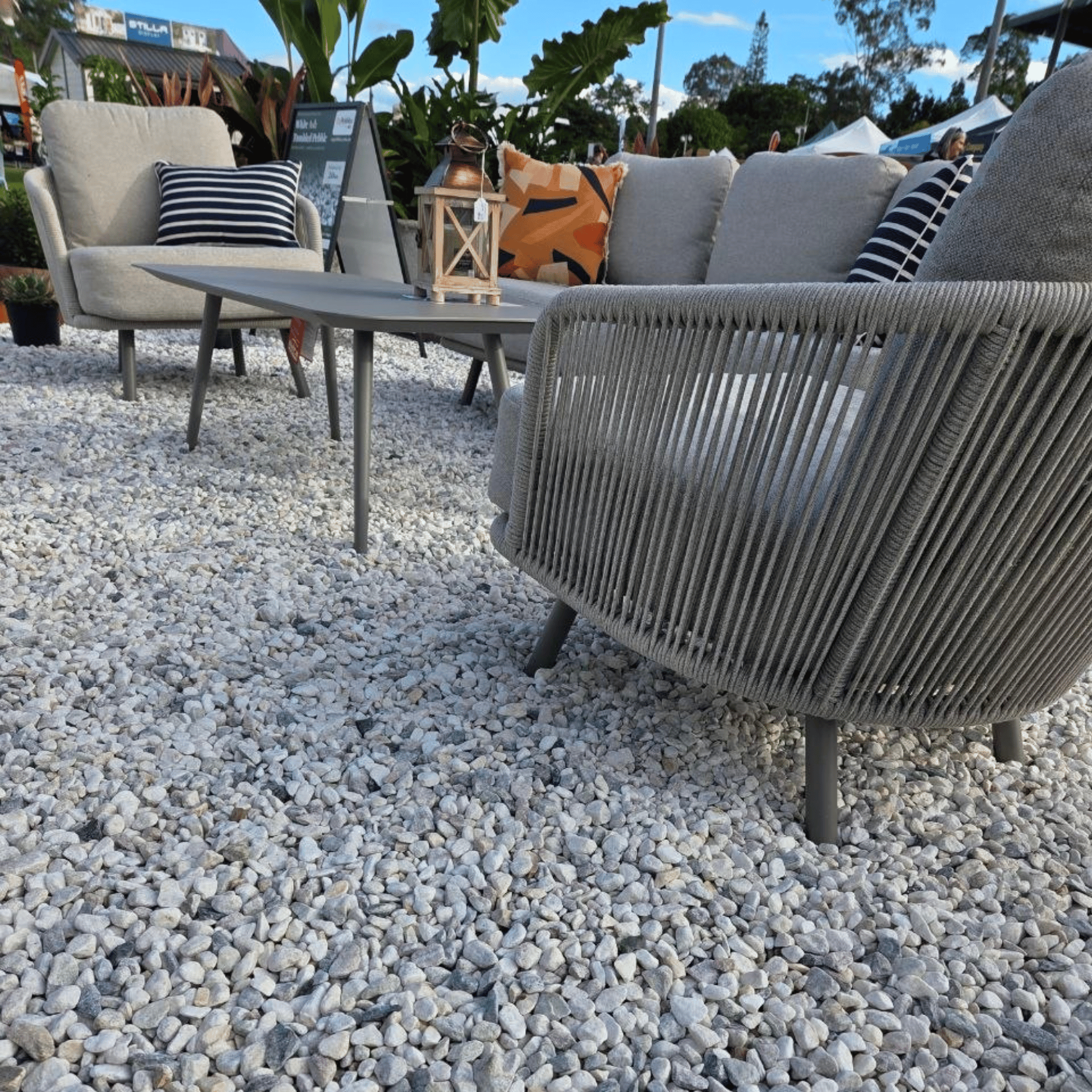 Valencia 4pce Lounge Setting with scatter cushions on gravel area, low angled-shot