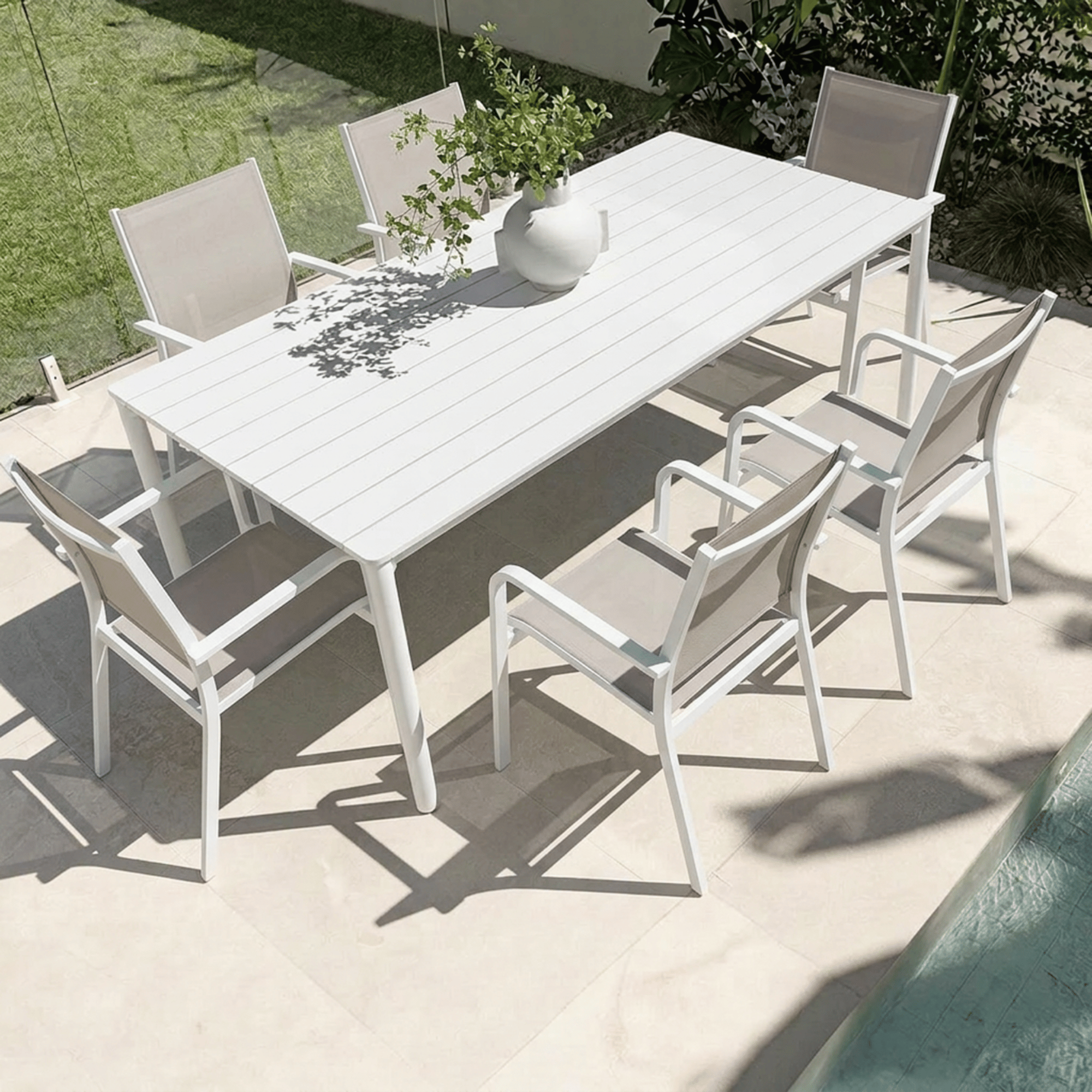 Mesa & Mons 200x100cm 7pce Dining Setting - White/Taupe
Outdoor dining set with a white table and chairs on a patio.