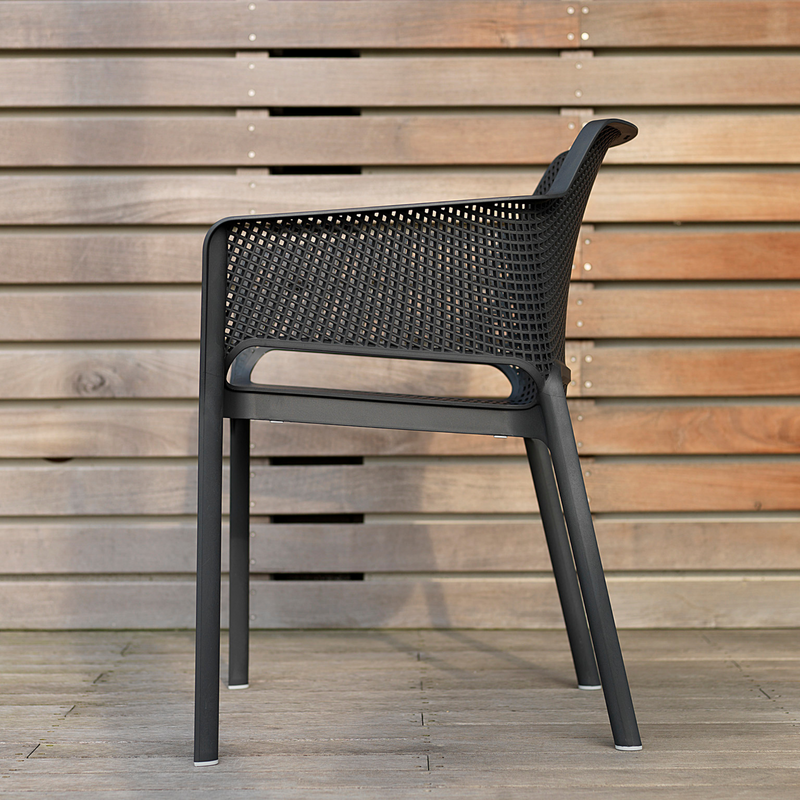 Net by Nardi means refined relaxation in an outdoor chair: a single-body chair in fiberglass resin, decorated with a radial pattern of square perforations across the whole surface of the seat.